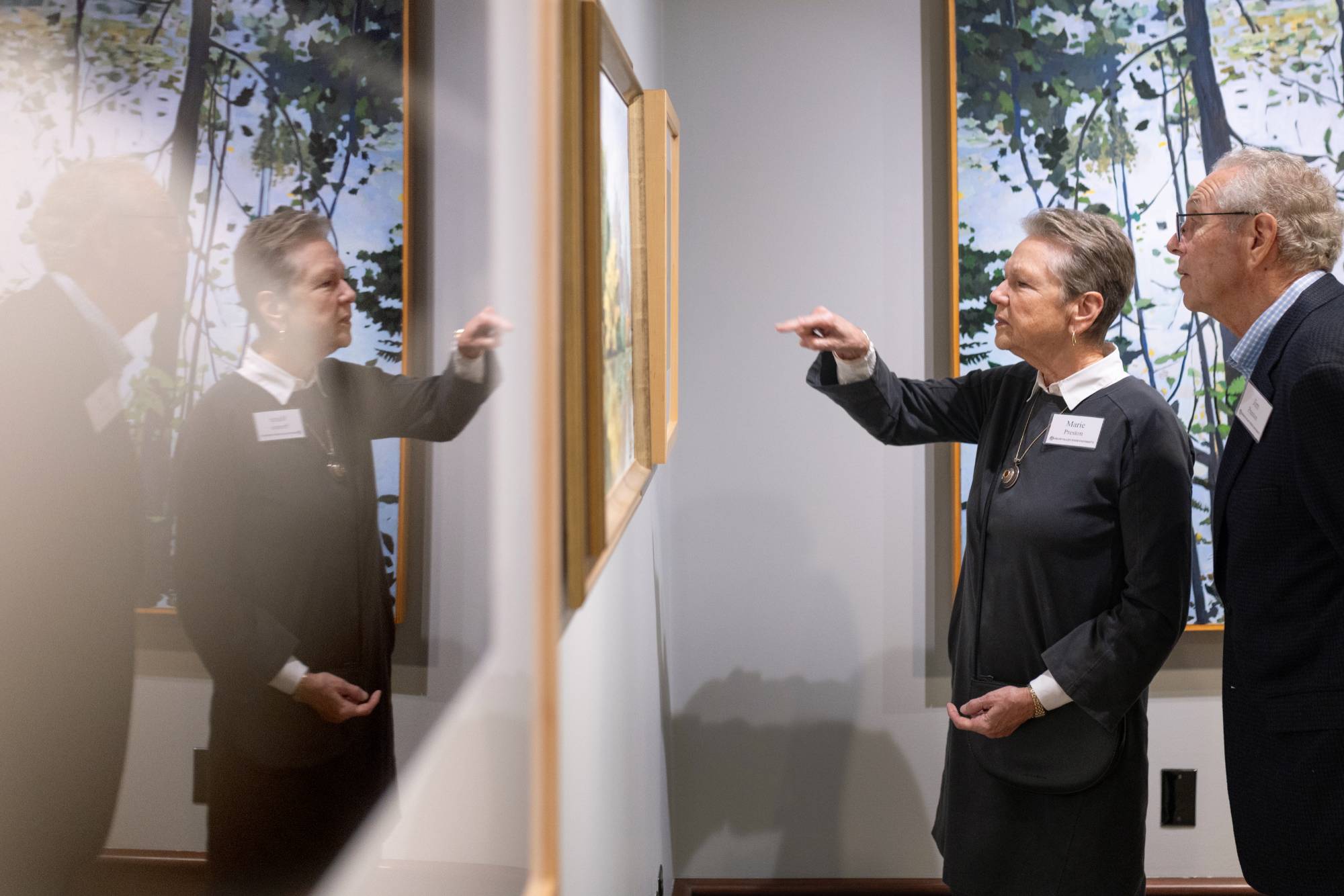 Two guests looking at artwork